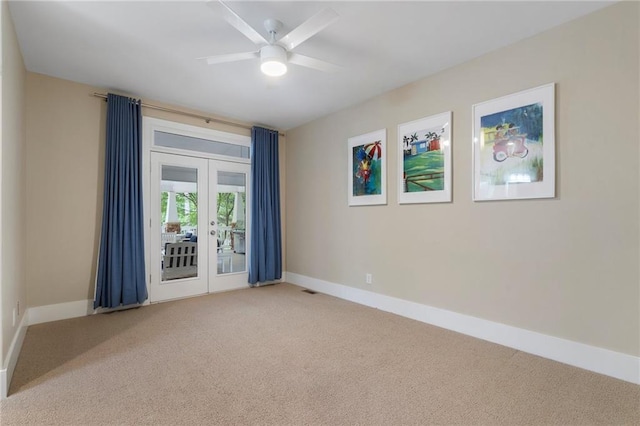 spare room featuring french doors, baseboards, ceiling fan, and carpet floors