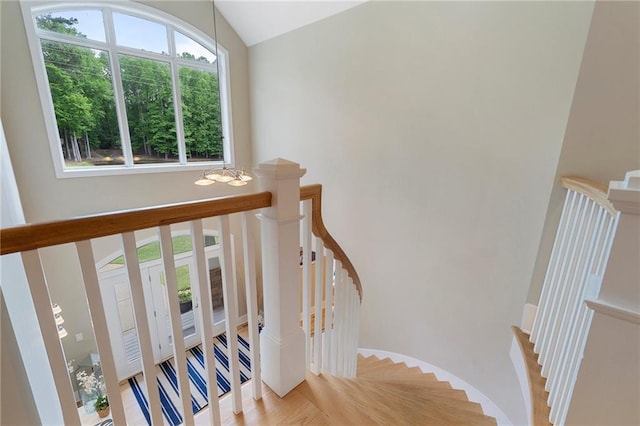 stairway featuring lofted ceiling