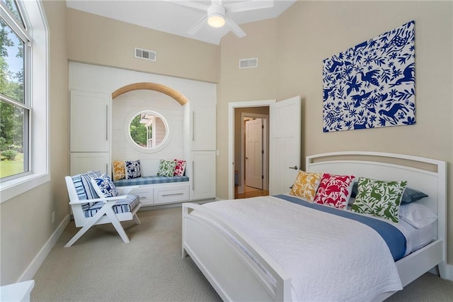 bedroom with visible vents, a ceiling fan, carpet floors, and vaulted ceiling