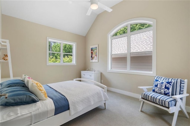 carpeted bedroom featuring a ceiling fan, baseboards, multiple windows, and lofted ceiling