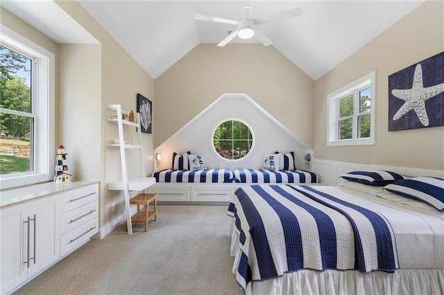bedroom with a ceiling fan, light colored carpet, and vaulted ceiling