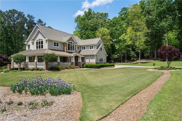 view of front of property with covered porch and a front lawn