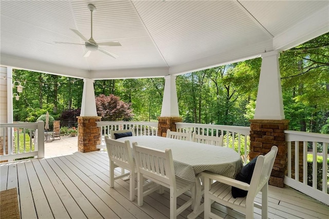 wooden deck featuring outdoor dining area and ceiling fan