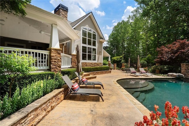 outdoor pool featuring a ceiling fan and a patio area