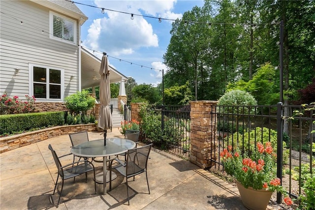 view of patio / terrace featuring fence and outdoor dining area
