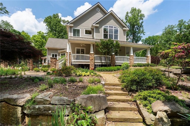 back of property with stairs, ceiling fan, and a porch
