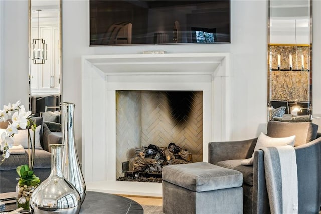 living area featuring an accent wall and wood finished floors