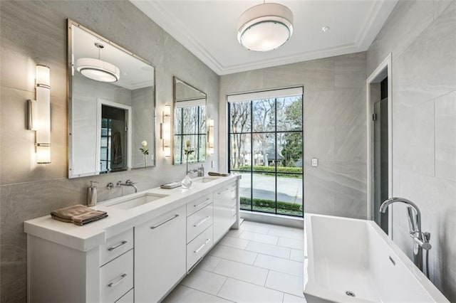 bathroom with ornamental molding, a sink, and tile walls