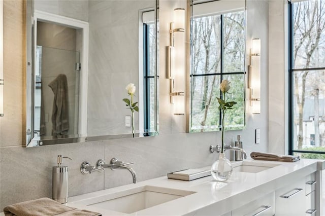 full bathroom with tasteful backsplash, a sink, and double vanity