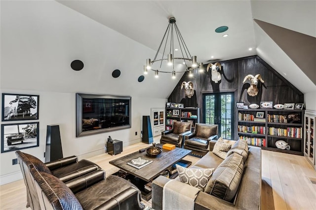 living area with lofted ceiling, french doors, baseboards, and wood finished floors