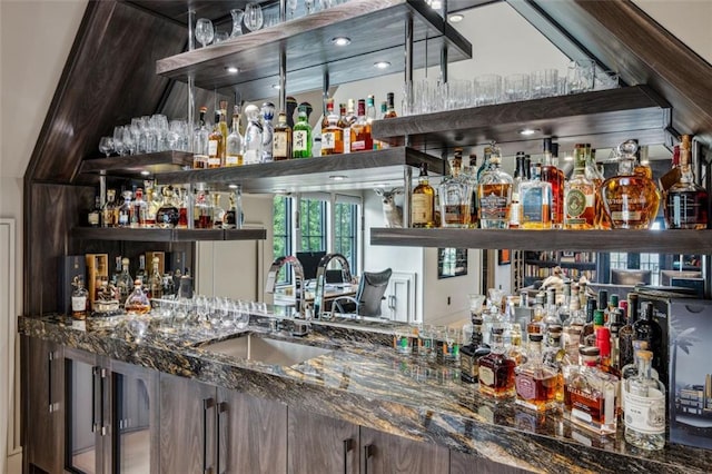 bar with indoor wet bar and a sink