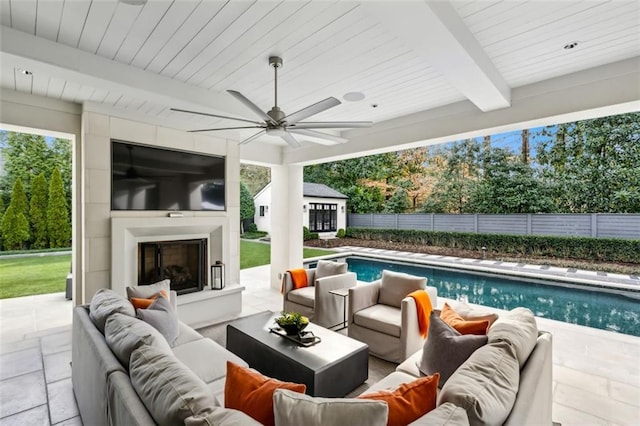 view of patio / terrace featuring a ceiling fan, a fenced in pool, fence, and an outdoor living space with a fireplace