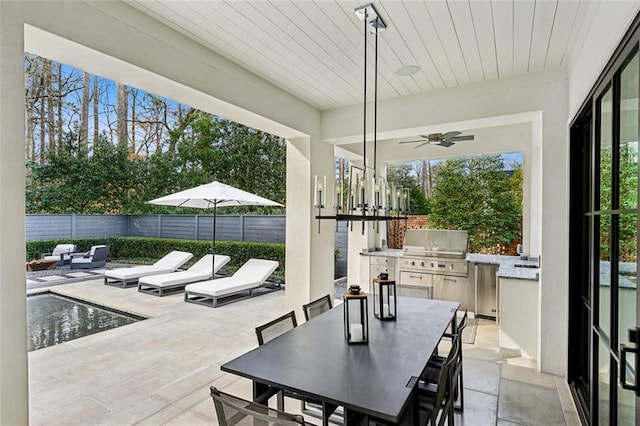 view of patio with a fenced in pool, outdoor dining area, a ceiling fan, exterior kitchen, and a fenced backyard