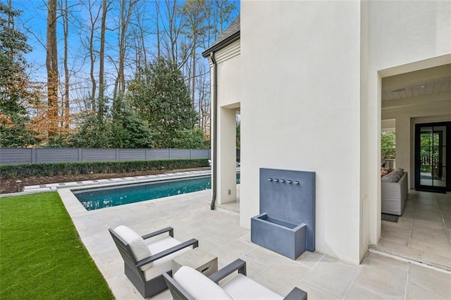 view of pool featuring fence, a fenced in pool, and a patio