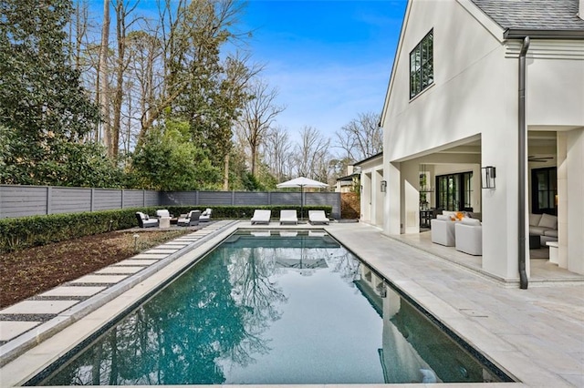 view of swimming pool featuring a patio, a fenced backyard, and a fenced in pool