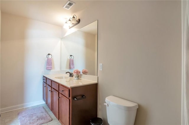 half bathroom with tile patterned floors, toilet, vanity, baseboards, and visible vents