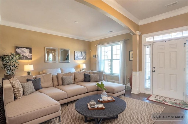 living room with hardwood / wood-style flooring and crown molding