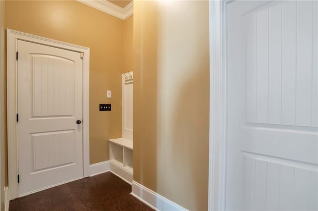 mudroom featuring ornamental molding, dark wood-style floors, and baseboards