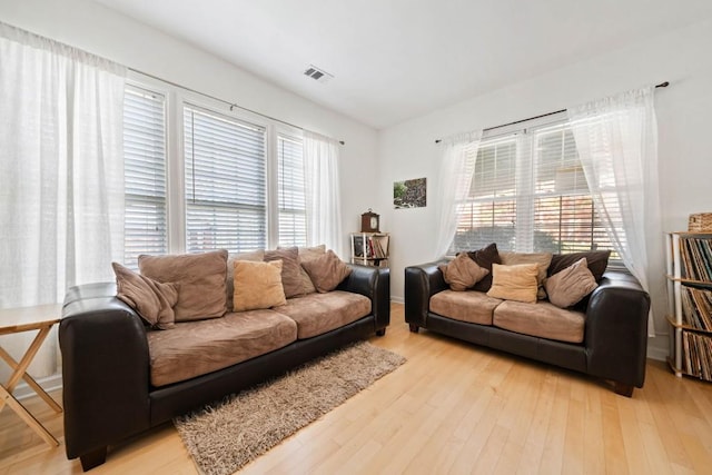 living area with visible vents and light wood finished floors