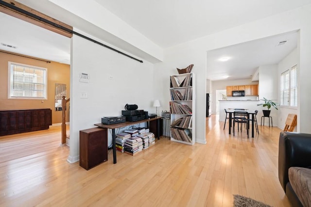 office space featuring visible vents, baseboards, and light wood-style floors