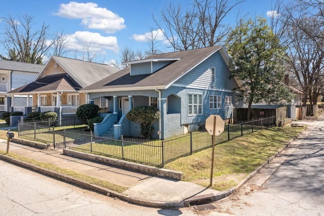 view of front of property with a fenced front yard, stucco siding, and a front lawn