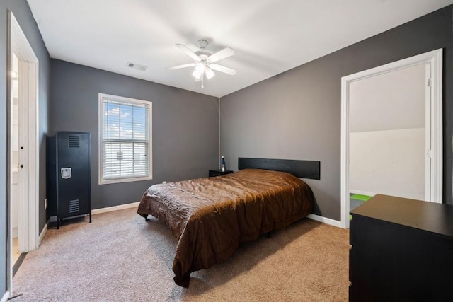 bedroom featuring a ceiling fan, baseboards, visible vents, and light carpet