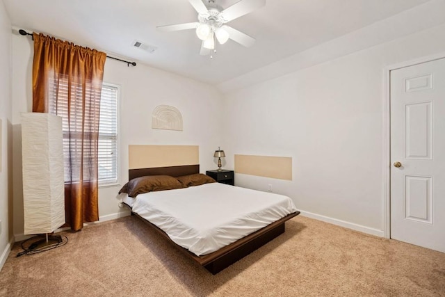 carpeted bedroom with visible vents, baseboards, a ceiling fan, and vaulted ceiling