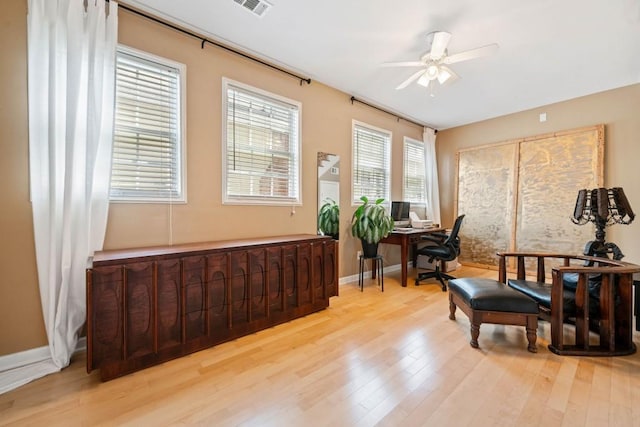 sitting room with ceiling fan, baseboards, and wood finished floors