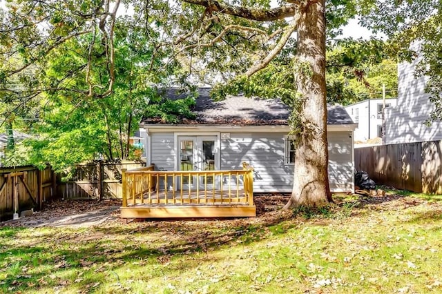 rear view of property with a deck and a lawn