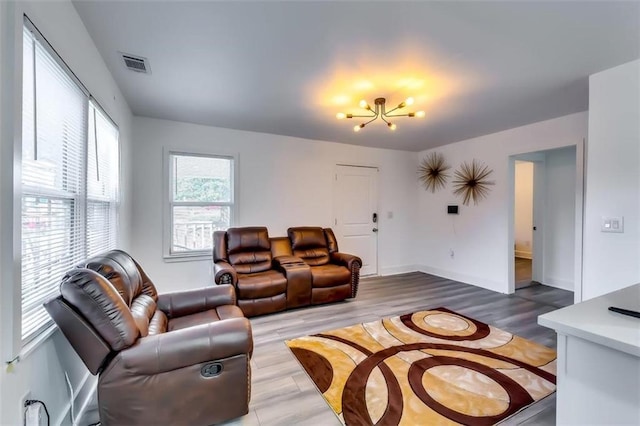 living room with a chandelier and wood-type flooring