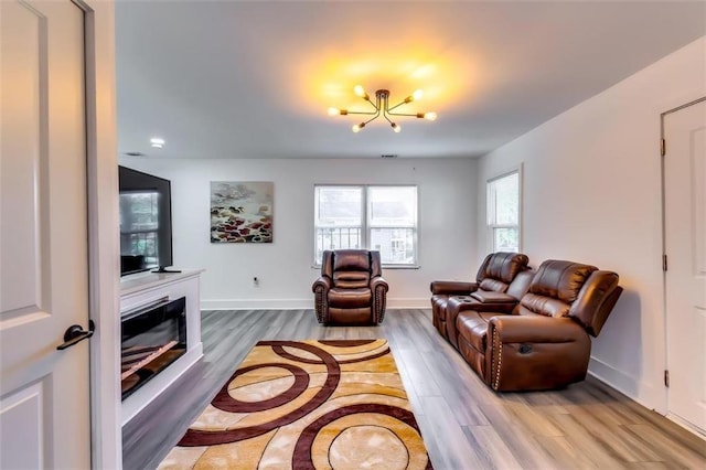 living room featuring light hardwood / wood-style floors and an inviting chandelier