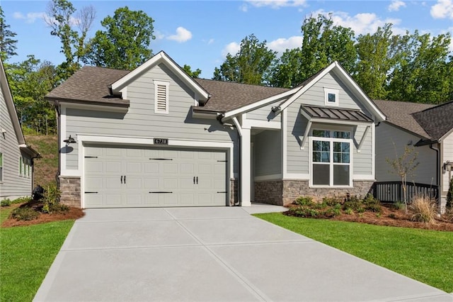 craftsman-style house with a standing seam roof, a garage, metal roof, stone siding, and concrete driveway