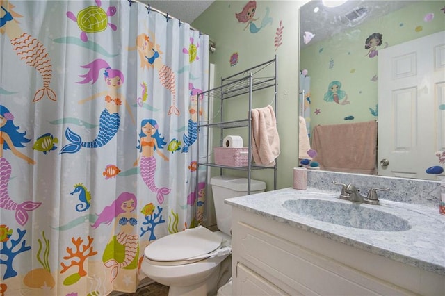 bathroom featuring vanity, a shower with curtain, and toilet