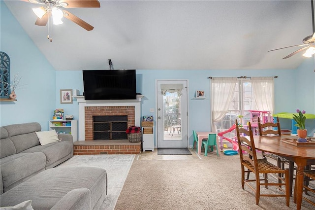 living room featuring light carpet, a brick fireplace, vaulted ceiling, and ceiling fan