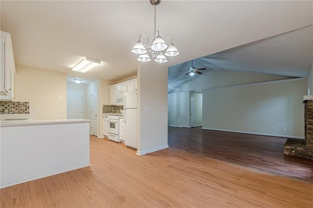 kitchen featuring light hardwood / wood-style flooring, white appliances, white cabinets, ceiling fan with notable chandelier, and tasteful backsplash