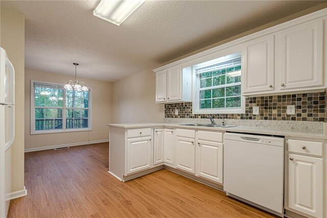 kitchen with white cabinets, a healthy amount of sunlight, and white appliances