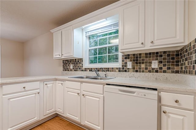 kitchen featuring decorative backsplash, white cabinets, dishwasher, light hardwood / wood-style floors, and sink