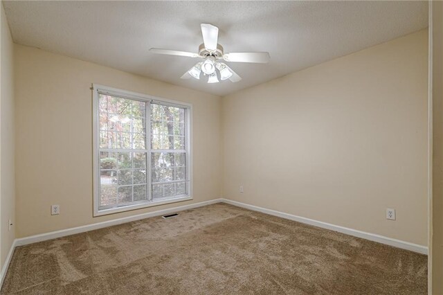 empty room featuring carpet flooring and ceiling fan