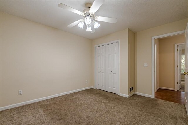 unfurnished bedroom with a closet, carpet floors, and ceiling fan