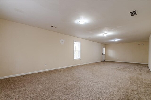 unfurnished room featuring light colored carpet