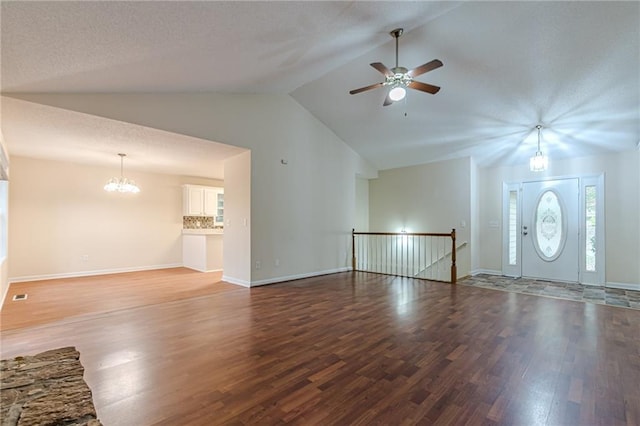 unfurnished living room with hardwood / wood-style floors, high vaulted ceiling, and ceiling fan with notable chandelier