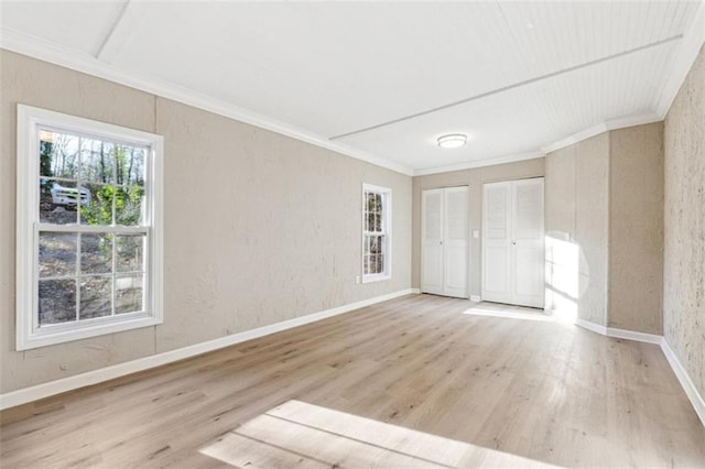 unfurnished room with light hardwood / wood-style floors and crown molding