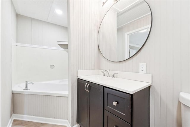 bathroom featuring wood-type flooring, toilet, and vanity