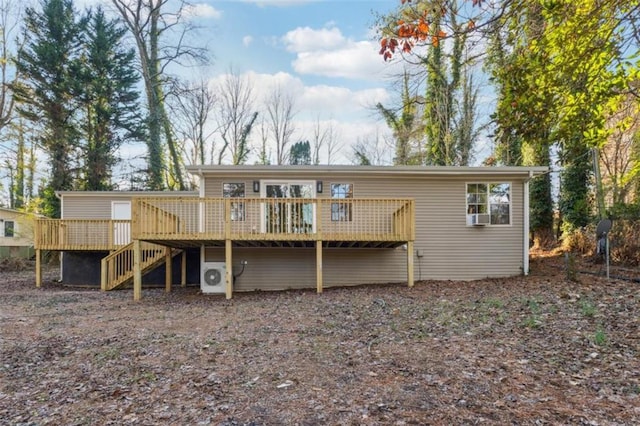 back of house with cooling unit and a deck