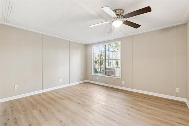 empty room featuring ceiling fan, cooling unit, and light hardwood / wood-style flooring