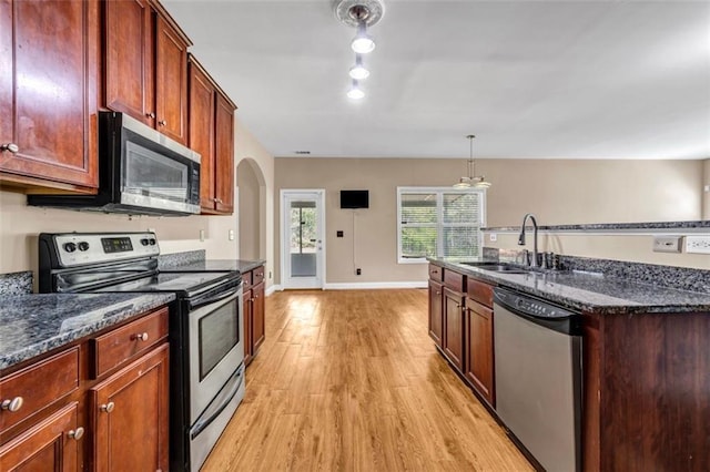 4499 Bellemeade Dr, Douglasville, GA 30135 - kitchen with light wood-style floors, dark stone countertops, stainless steel appliances, and a sink