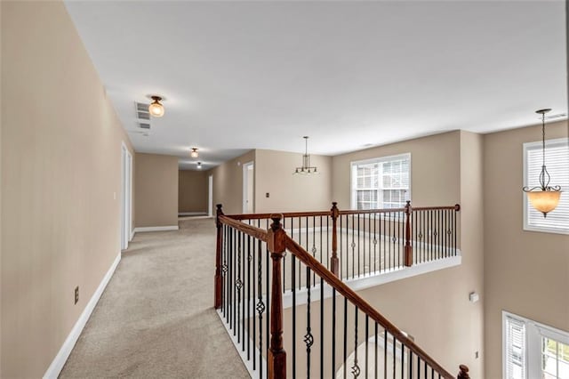 4499 Bellemeade Dr, Douglasville, GA 30135 - hallway with baseboards, light colored carpet, and a healthy amount of sunlight