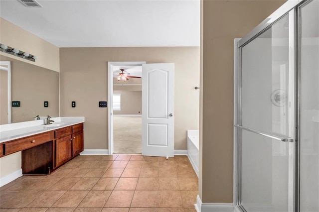 4499 Bellemeade Dr, Douglasville, GA 30135 - full bath featuring a bath, a stall shower, baseboards, ceiling fan, and vanity