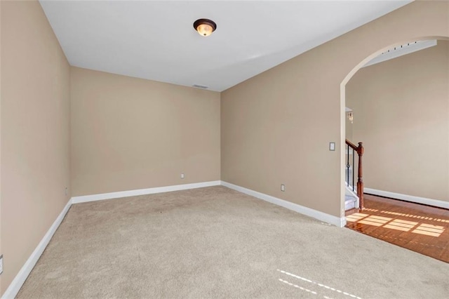 4499 Bellemeade Dr, Douglasville, GA 30135 - unfurnished room with stairway, arched walkways, carpet floors, and baseboards