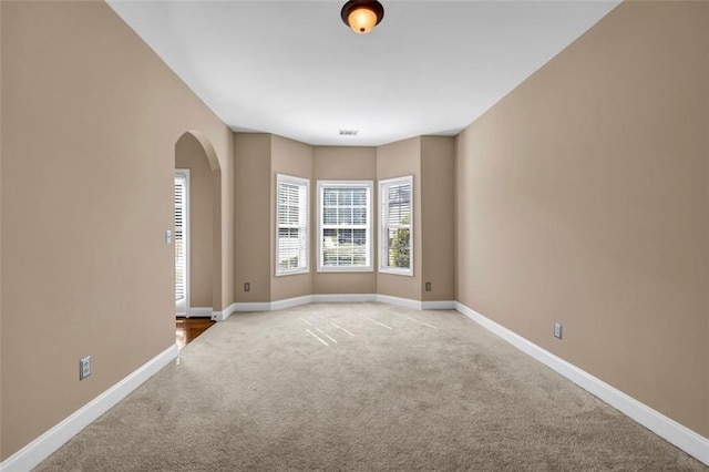 4499 Bellemeade Dr, Douglasville, GA 30135 - carpeted empty room featuring arched walkways, visible vents, and baseboards